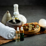Herbal compress and herbal spa treatment equipments put on dark floor
